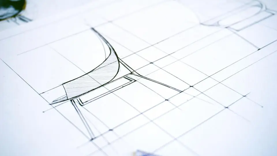 A pencil design drawing of a curved seat on gridded paper, with faint construction lines ruled through it.