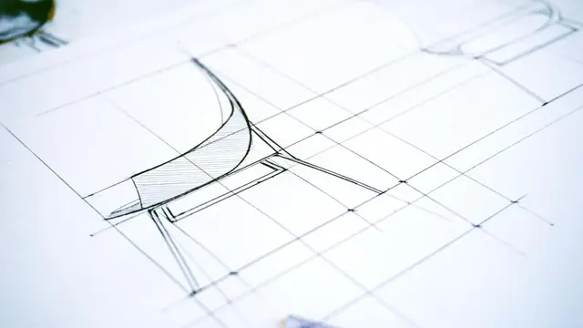 A pencil design drawing of a curved seat on gridded paper, faint construction lines ruled through it.